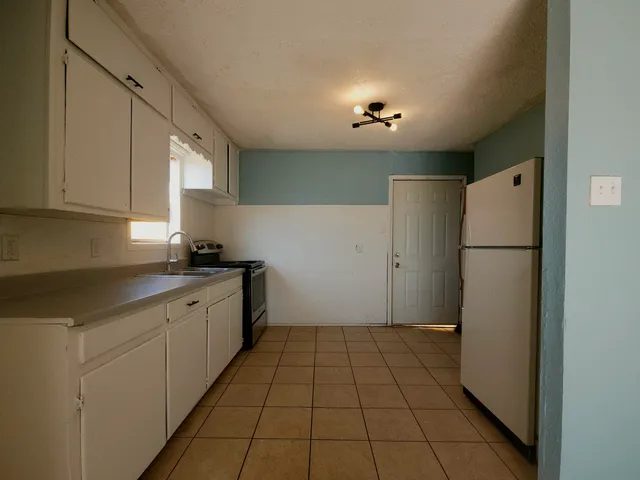 a kitchen with a refrigerator and a sink