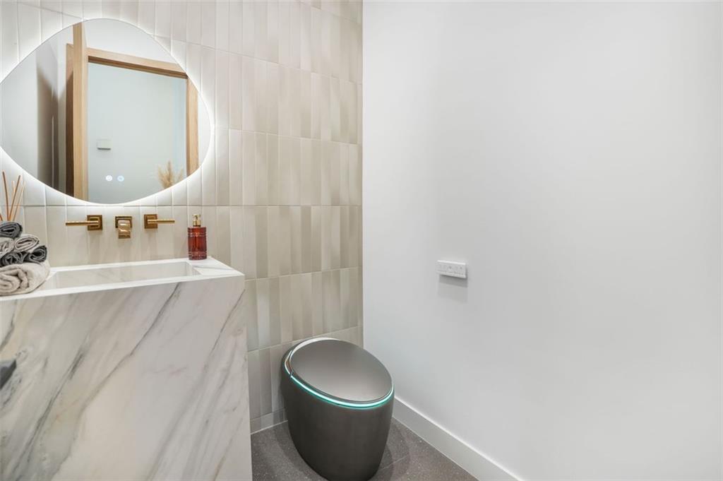 1736 Cox Road Roswell, GA 30075 - Photo 11 of 92 a bathroom with a sink a toilet and mirror