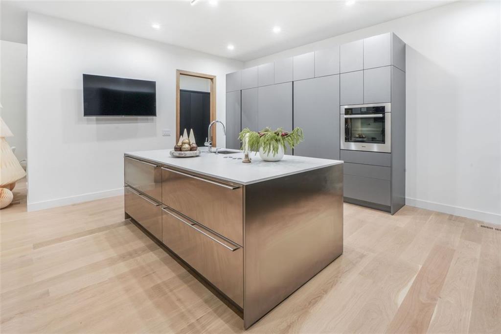 1736 Cox Road Roswell, GA 30075 - Photo 21 of 92 a living room with stainless steel appliances kitchen island furniture and a television
