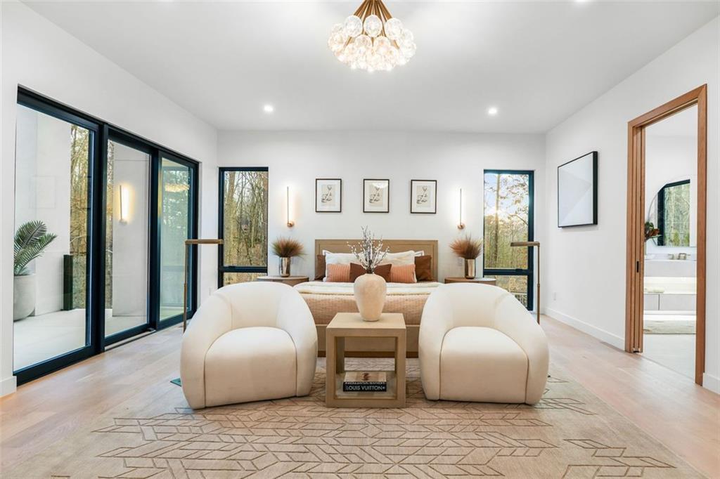 1736 Cox Road Roswell, GA 30075 - Photo 36 of 92 a spacious bedroom with a bed and a chandelier