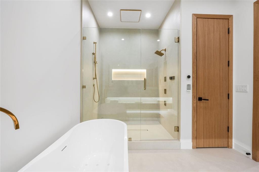 1736 Cox Road Roswell, GA 30075 - Photo 46 of 92 a bathroom with a bathtub and a shower