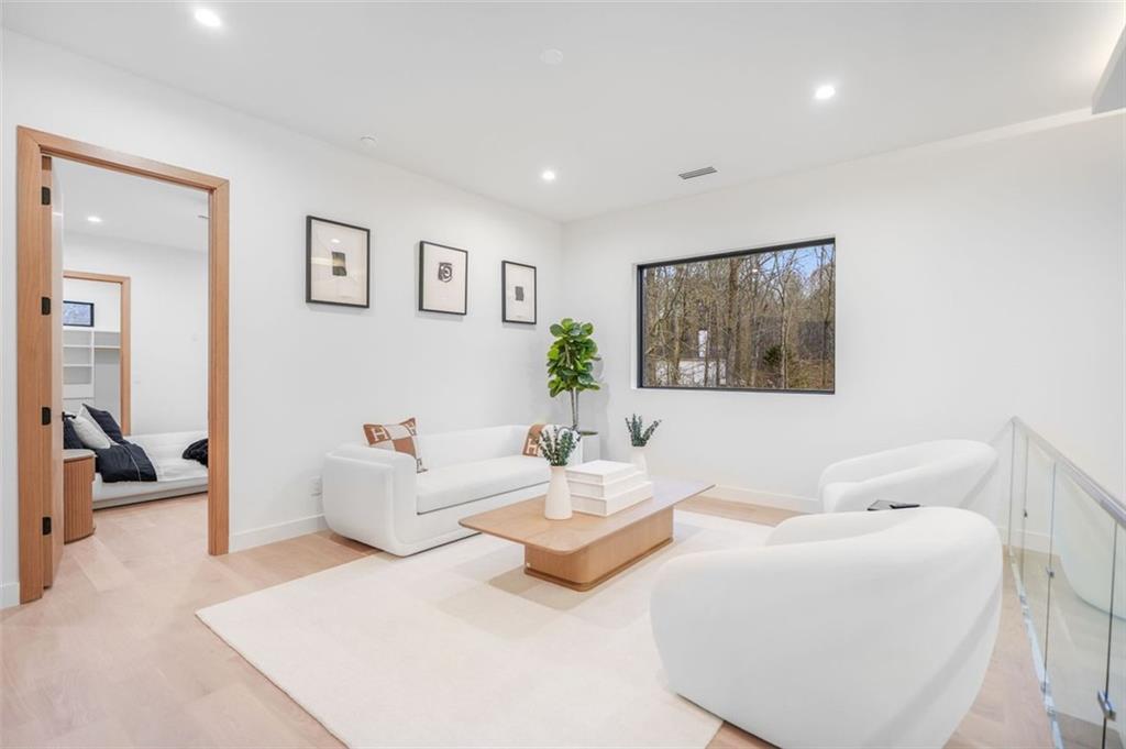 1736 Cox Road Roswell, GA 30075 - Photo 63 of 92 a living room with furniture and a painting on the wall