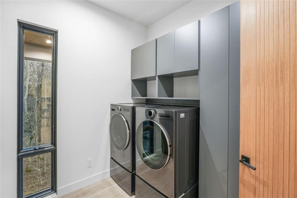 1736 Cox Road Roswell, GA 30075 - Photo 65 of 92 a utility room with dryer and washer