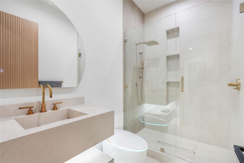 1736 Cox Road Roswell, GA 30075 - Photo 69 of 92 a bathroom with a sink a toilet and shower