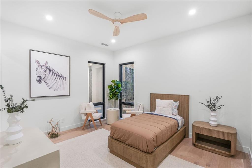 1736 Cox Road Roswell, GA 30075 - Photo 73 of 92 a bedroom with a bed a couch and potted plant on the dresser