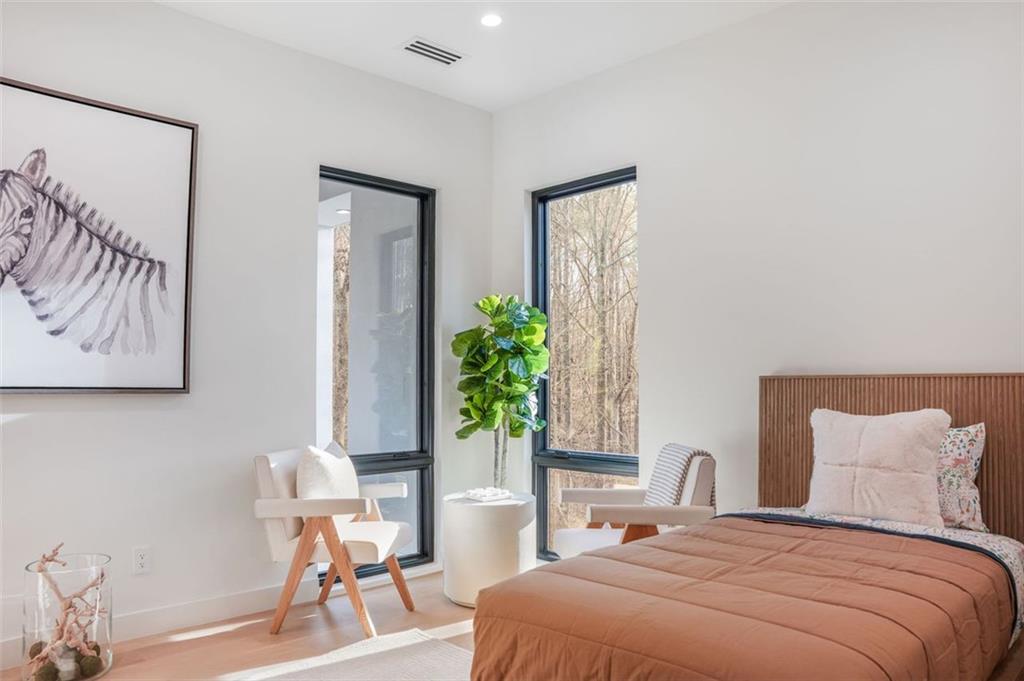 1736 Cox Road Roswell, GA 30075 - Photo 74 of 92 a bedroom with a bed and a potted plant