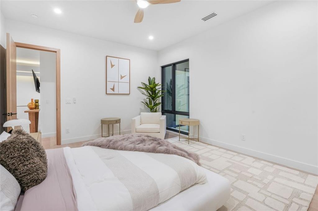 1736 Cox Road Roswell, GA 30075 - Photo 76 of 92 a bedroom with a large bed and a potted plant