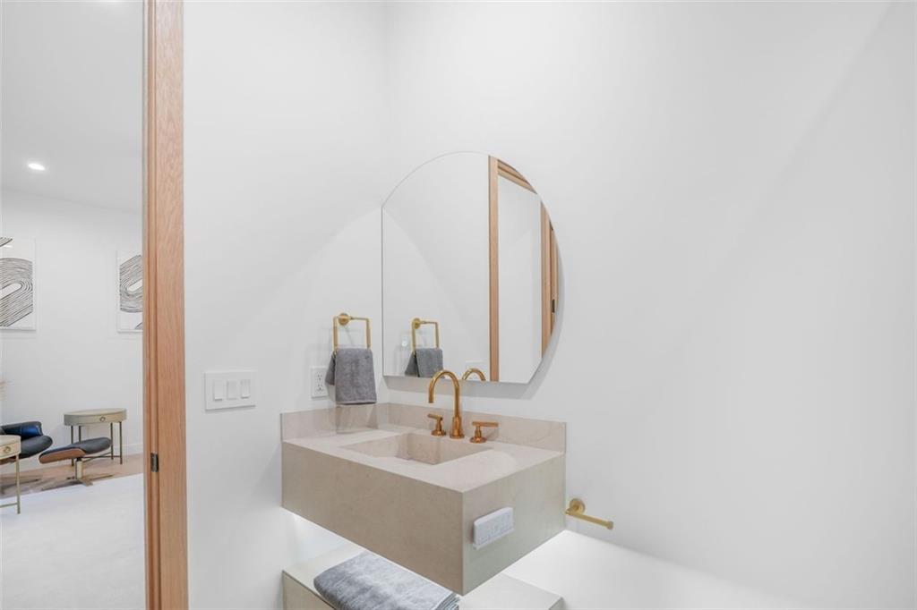 1736 Cox Road Roswell, GA 30075 - Photo 82 of 92 a bathroom with a sink and a mirror