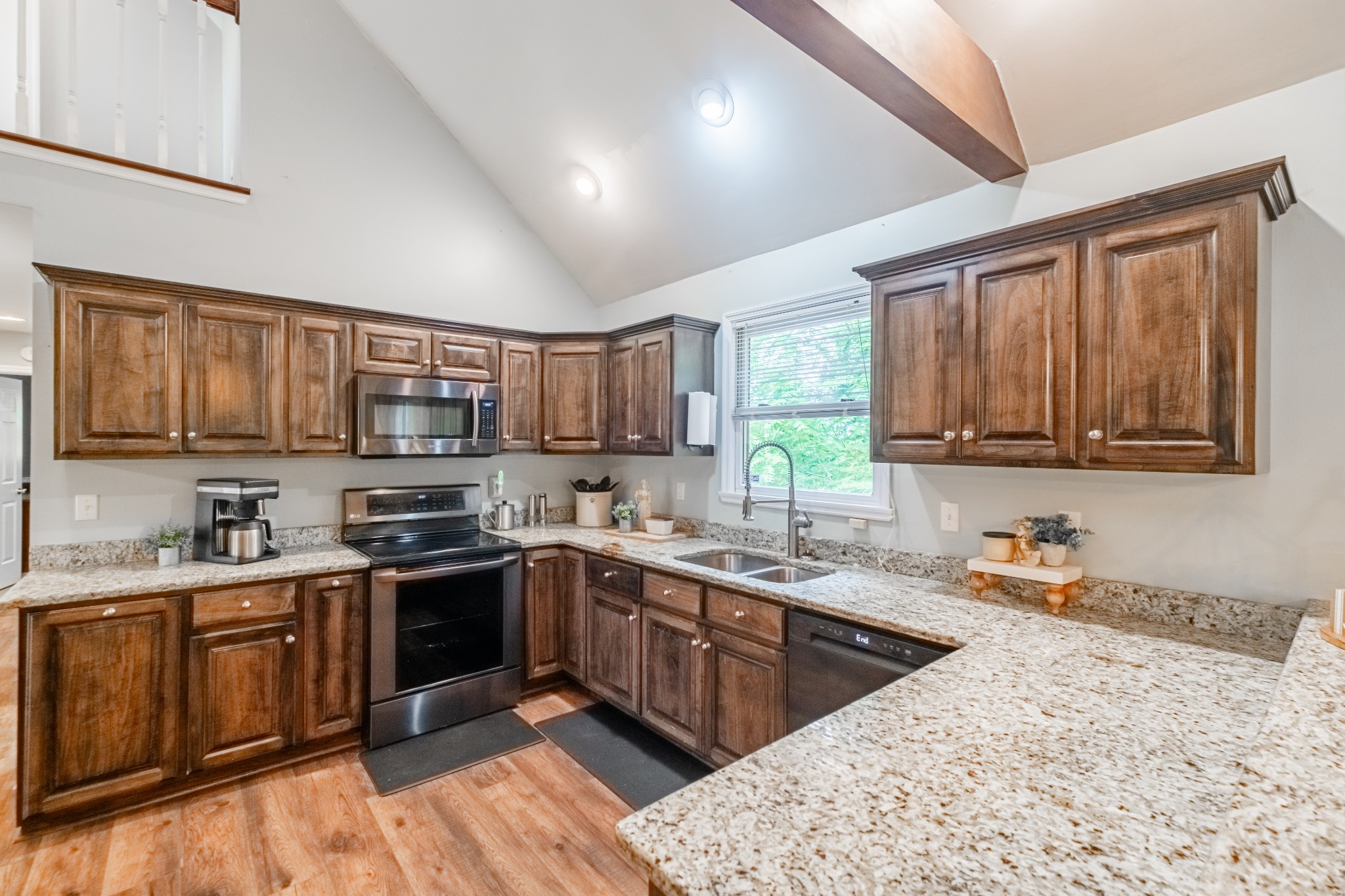 255 Flora Lane Manchester, TN 37355 - Photo 16 of 53 a kitchen with stainless steel appliances granite countertop a sink stove top oven and cabinets