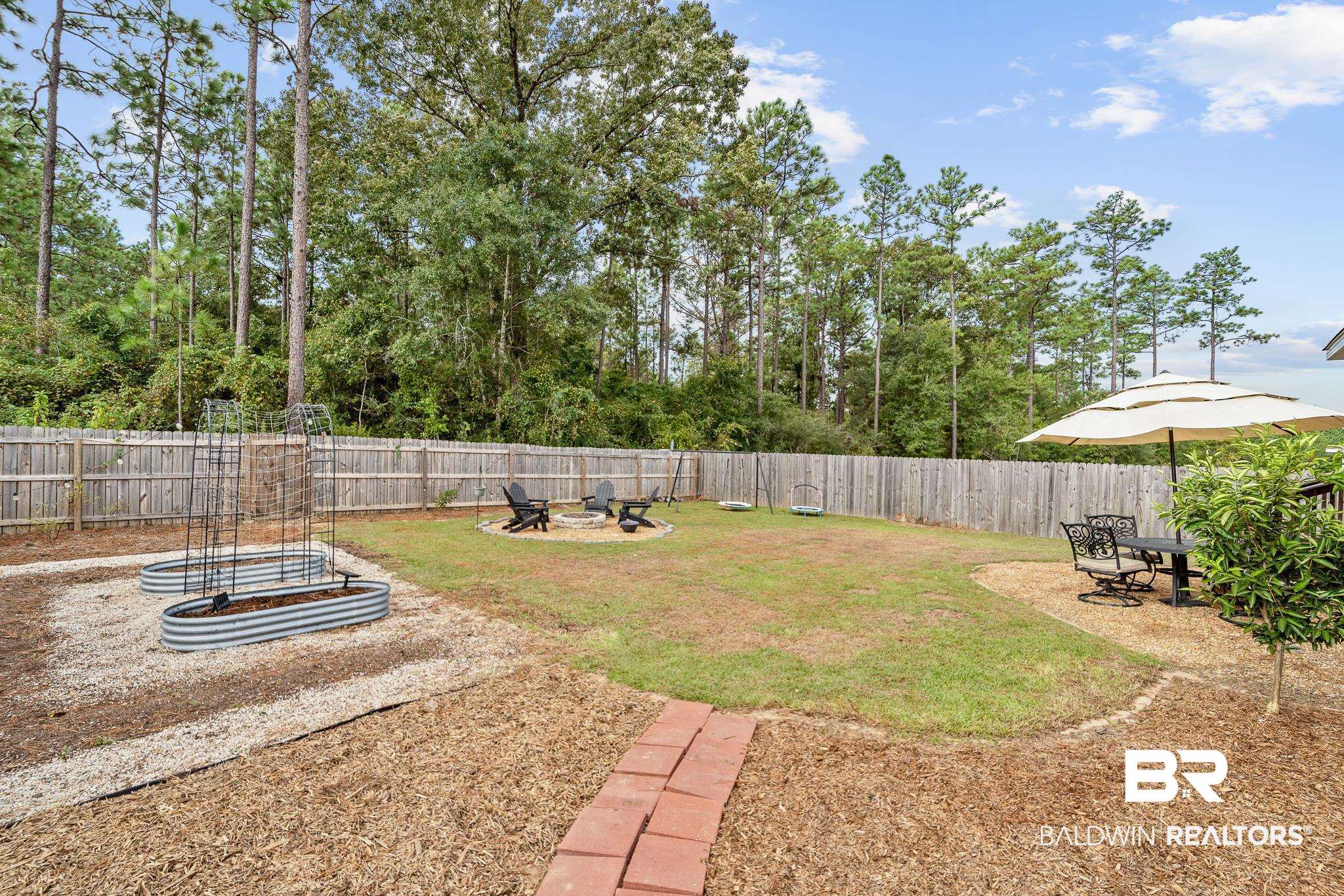 10516 Brodick Loop Daphne, AL 36527 - Photo 26 of 27 View of yard with a fire pit