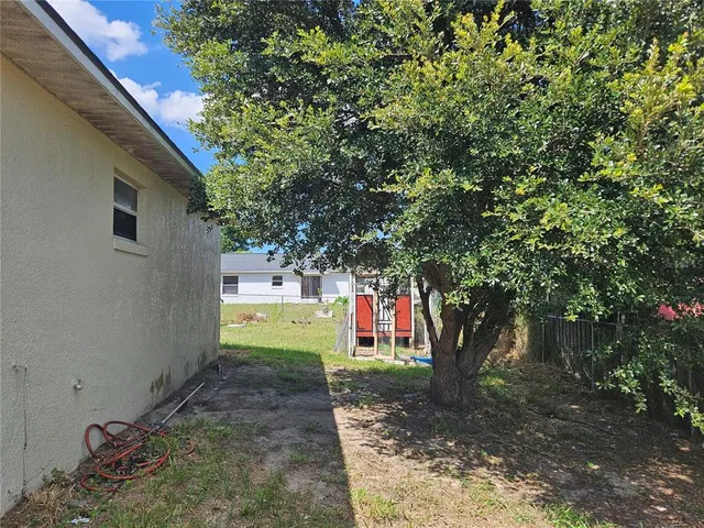 a view of a house with a tree back yard
