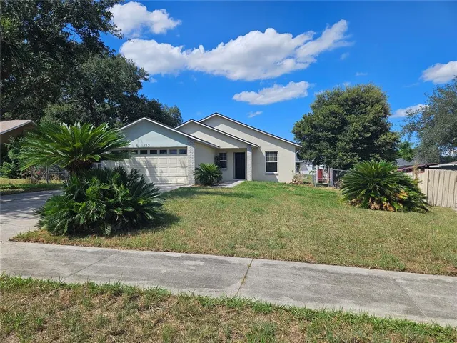 a front view of a house with a garden