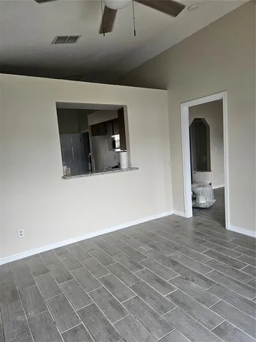 a view of a livingroom with an empty space and wooden floor