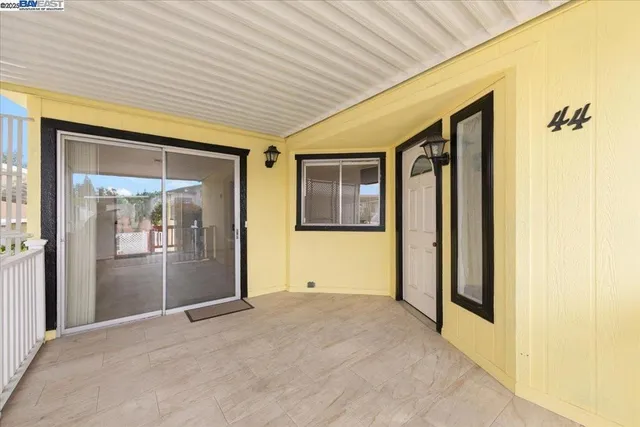a view of a porch with wooden floor and a table
