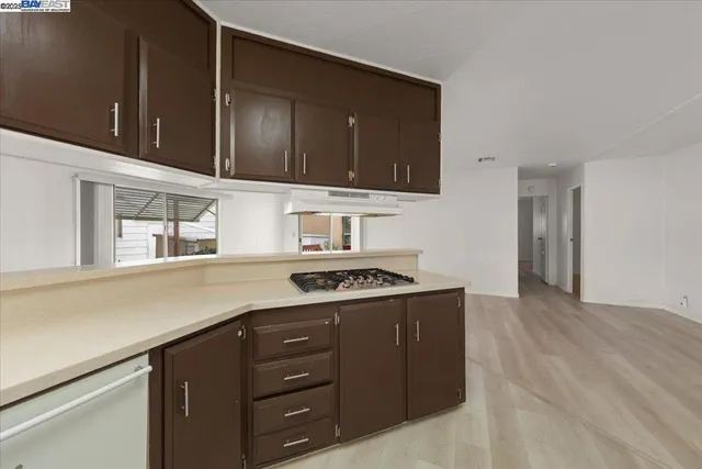 a kitchen with a cabinets and a stove top oven