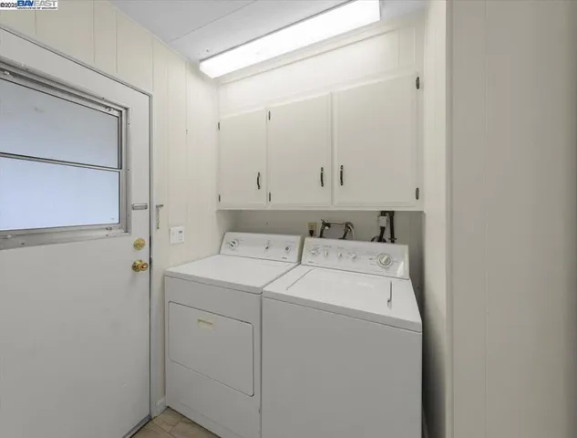 a view of storage and utility room with washer and dryer