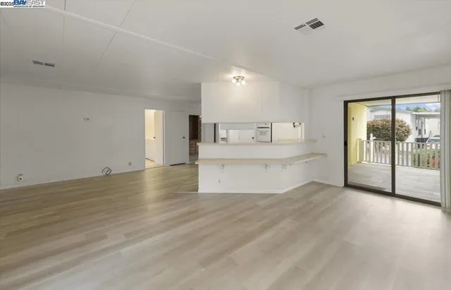 a view of a kitchen with a sink and a window