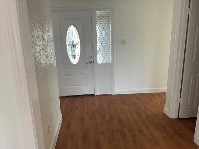 a living room with furniture fireplace and wooden floor