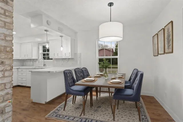 a bedroom with a bed a ceiling fan and a dresser