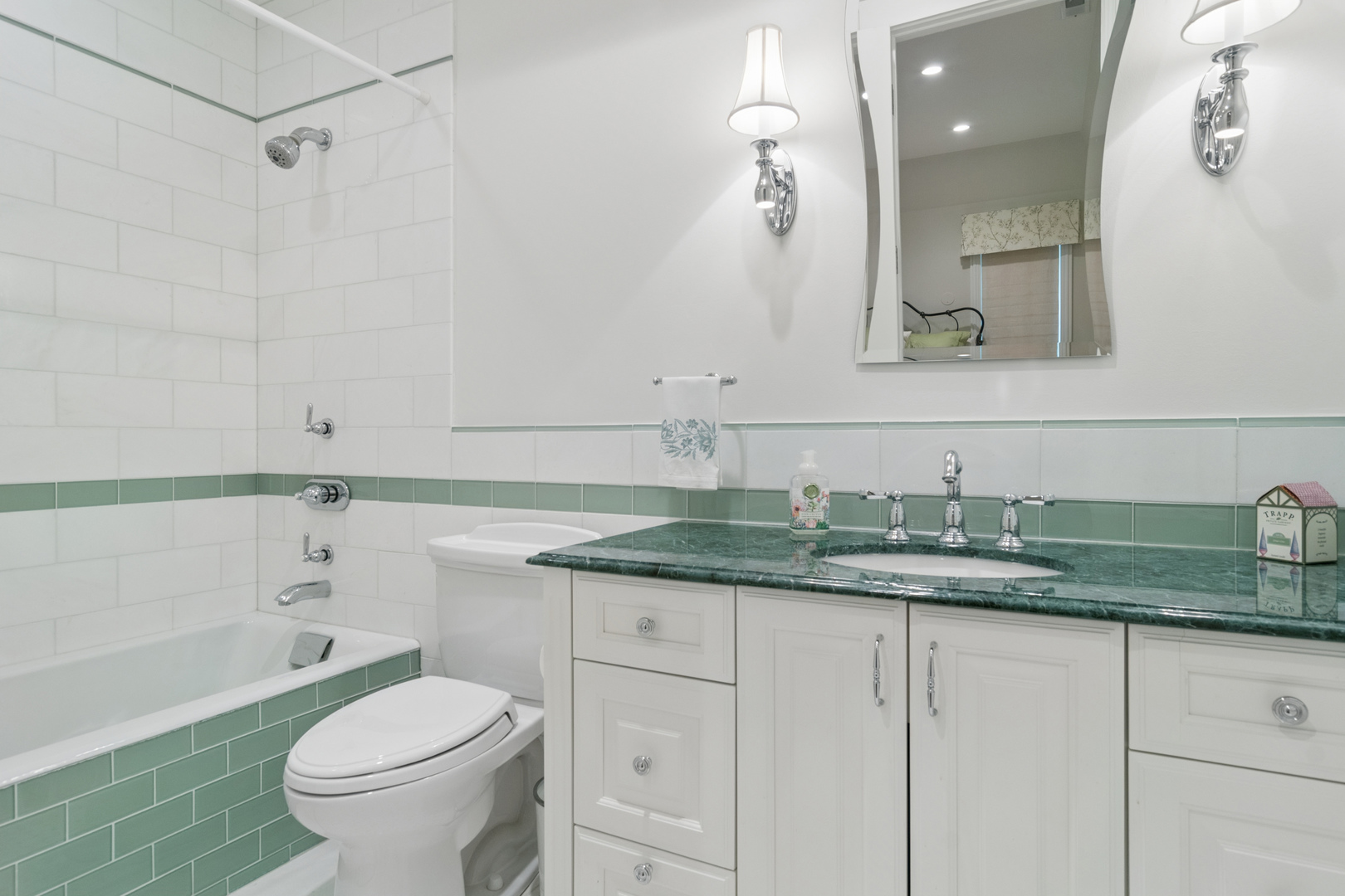 1128 Mt Pleasant Road Winnetka, IL 60093 - Photo 37 of 58 a bathroom with a granite countertop sink a toilet and a bathtub