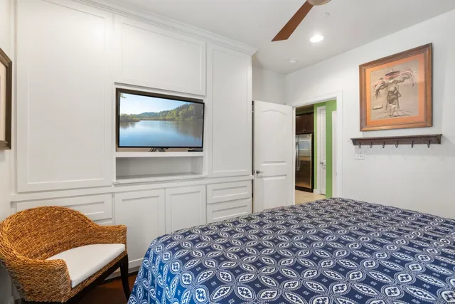 a bedroom with a bed and a flat screen tv