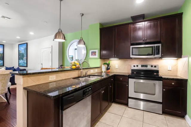 a kitchen with a sink stove and microwave