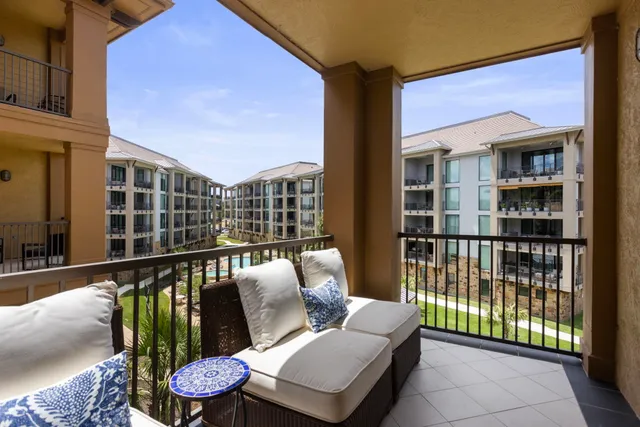 a balcony with furniture and city view