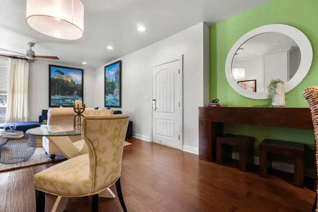 a living room with furniture a mirror and a fireplace