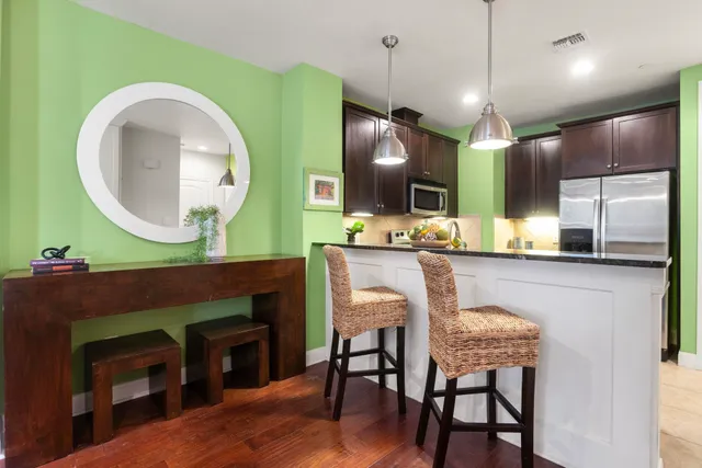 a living room with kitchen view and a fireplace