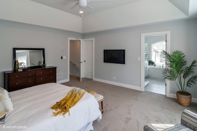 204 Fairbank Road Riverside, IL 60546 - Photo 12 of 24 a spacious bedroom with a bed and a flat screen tv