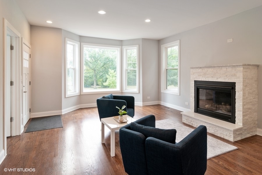 204 Fairbank Road Riverside, IL 60546 - Photo 3 of 24 a living room with furniture a fireplace and a floor to ceiling window