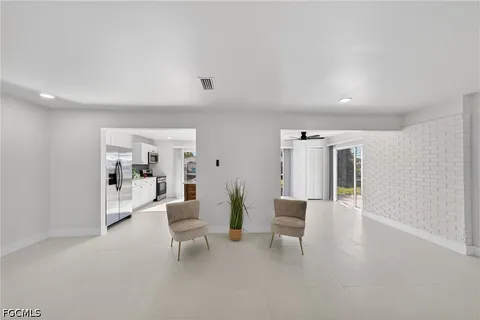 a living room with furniture and a lamp