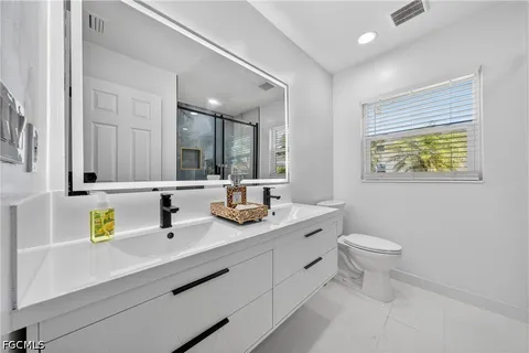 a bathroom with 2 sink and a toilet