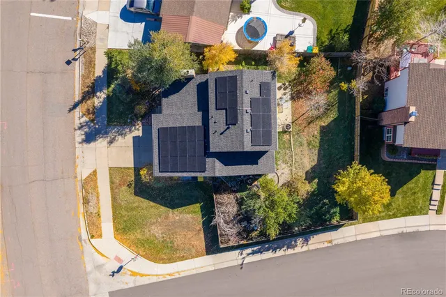 front view of a house with a yard and potted plants