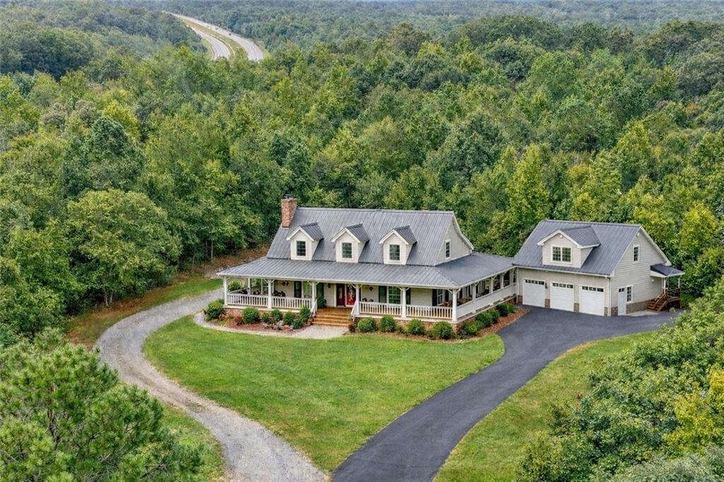 an aerial view of a house with a big yard