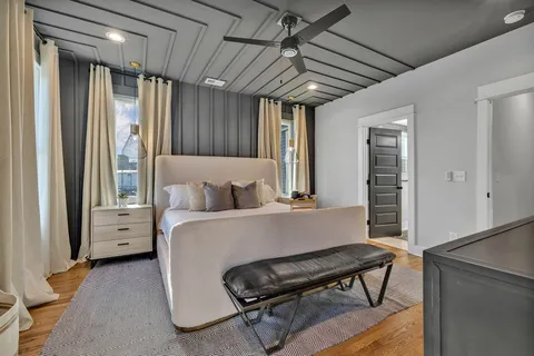 a bedroom with a bed and a chandelier