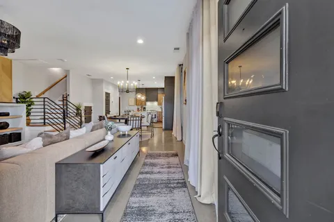 a large white kitchen with a large window