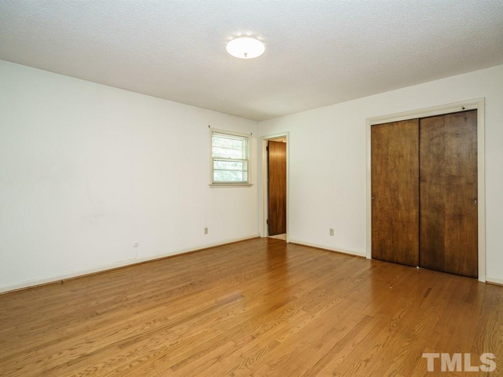4305 Rowan Street Raleigh, NC 27609 - Photo 13 of 22 an empty room with wooden floor and windows