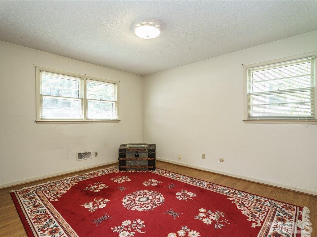 4305 Rowan Street Raleigh, NC 27609 - Photo 15 of 22 a view of an empty room with a rug