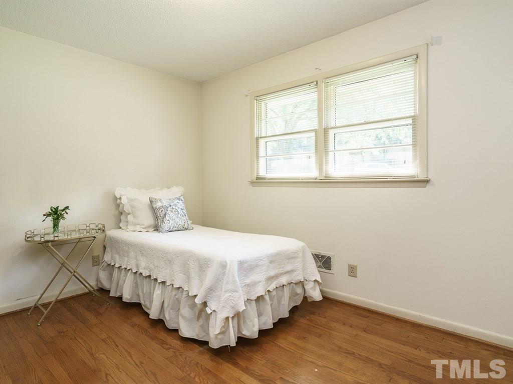 4305 Rowan Street Raleigh, NC 27609 - Photo 17 of 22 a bedroom with a bed and window
