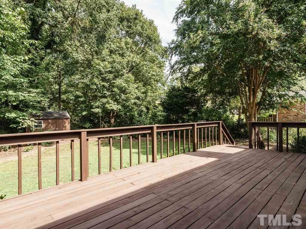 4305 Rowan Street Raleigh, NC 27609 - Photo 18 of 22 a balcony with wooden floor and fence