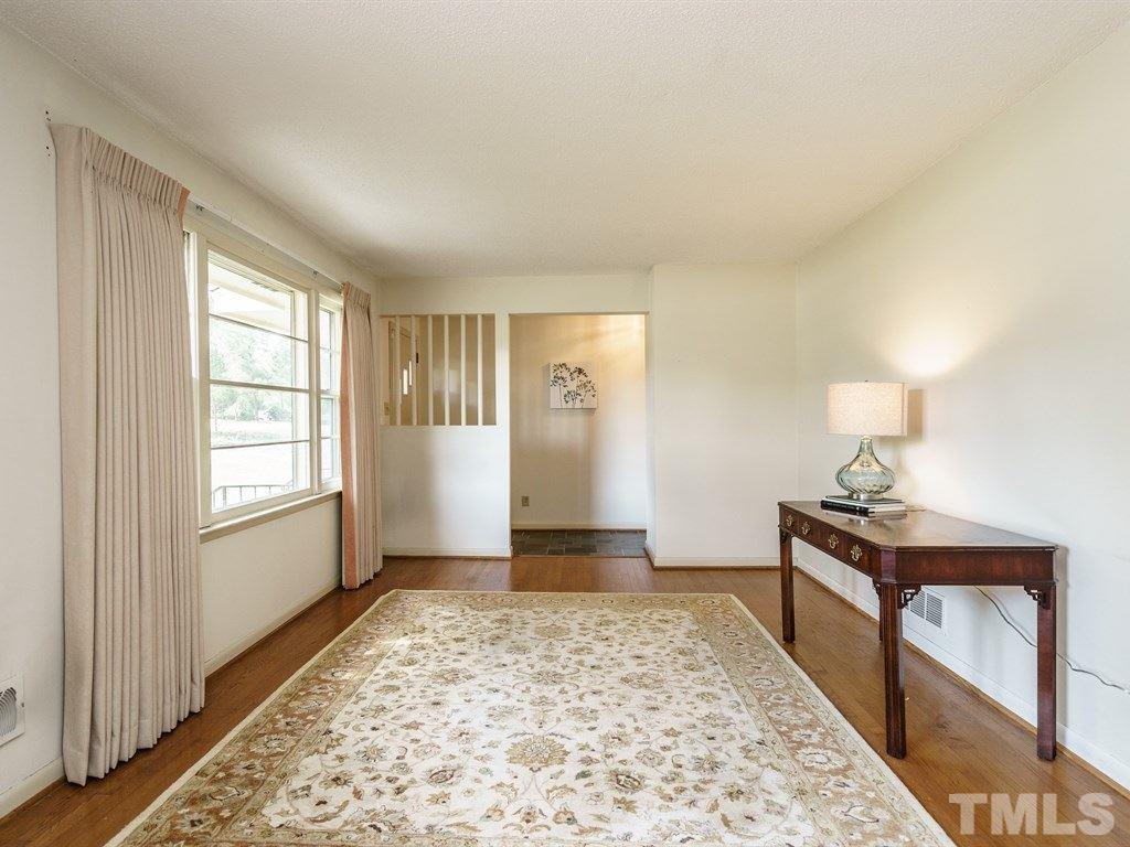 4305 Rowan Street Raleigh, NC 27609 - Photo 6 of 22 a bedroom with a bed and wooden floor