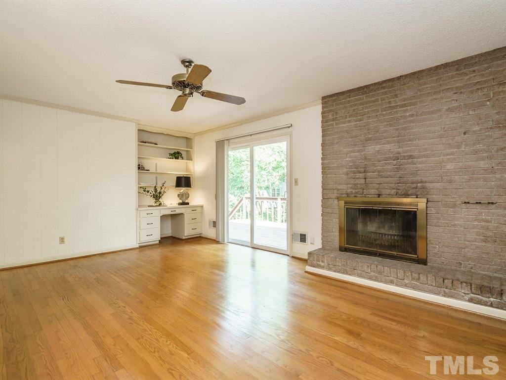 4305 Rowan Street Raleigh, NC 27609 - Photo 9 of 22 a view of a livingroom with a fireplace and window