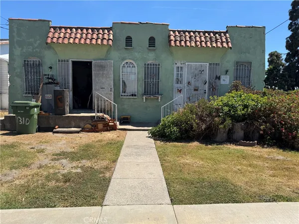 a view of a house with potted plants