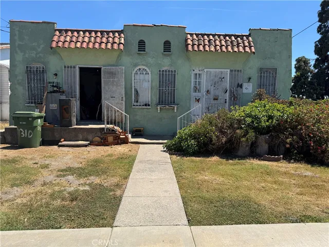 a view of a house with potted plants