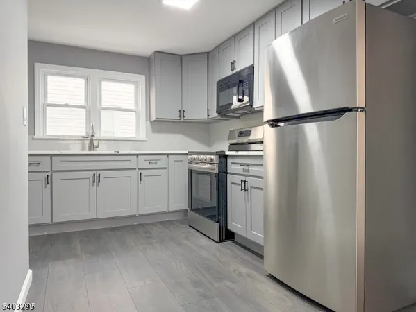 a kitchen with white cabinets and white appliances