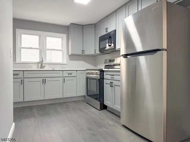 a kitchen with white cabinets and white appliances