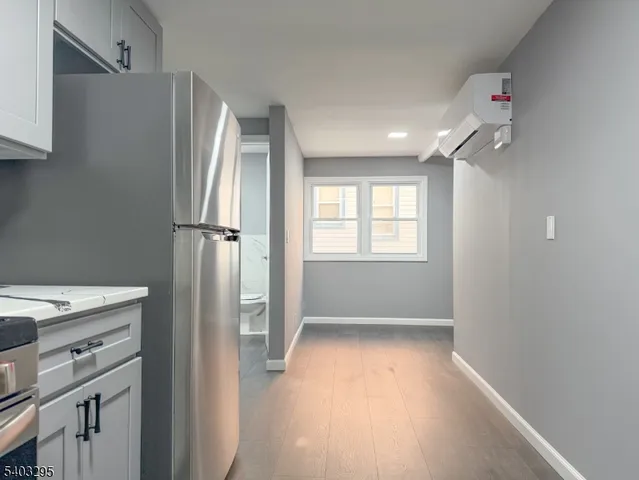 a view of a kitchen with a refrigerator and window