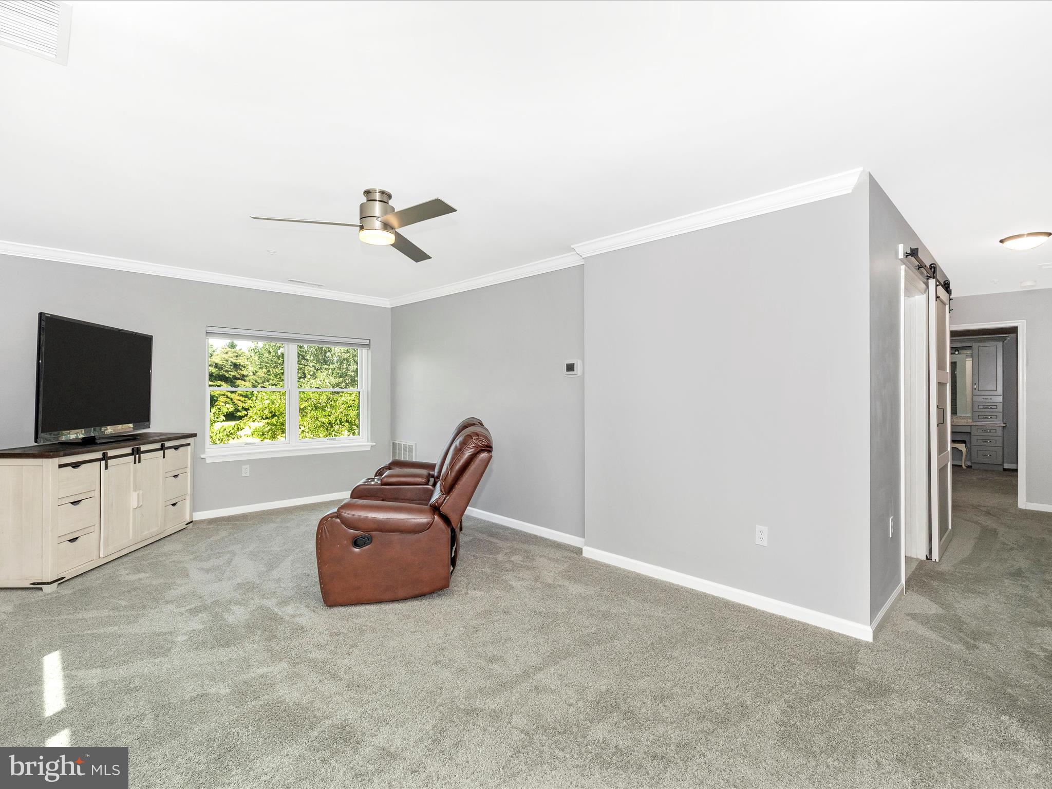 102 Mercer Court, Unit 22 1A Frederick, MD 21701 - Photo 26 of 56 a living room with furniture and a flat screen tv