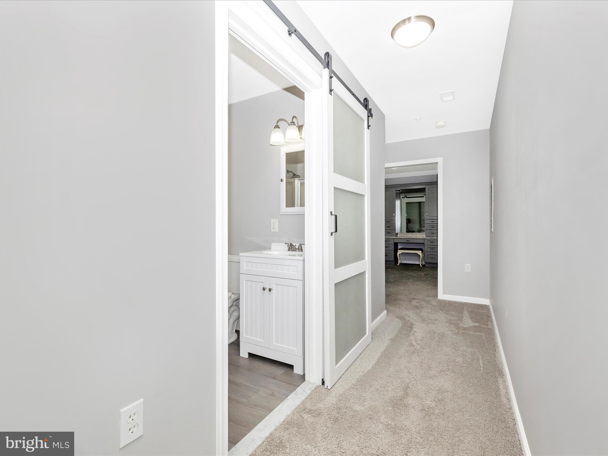 102 Mercer Court, Unit 22 1A Frederick, MD 21701 - Photo 28 of 56 a view of a walk in closet with living room
